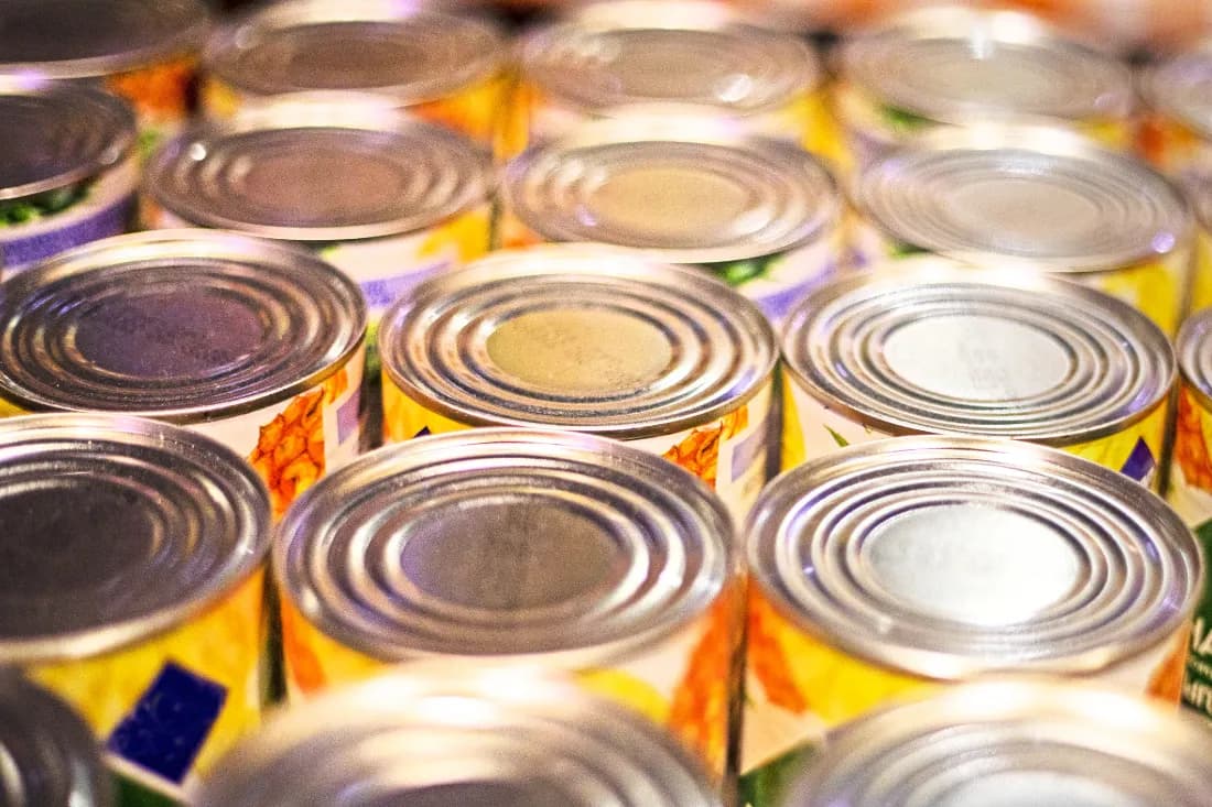 Cases of tinned food packed lid-to-lid in rows.