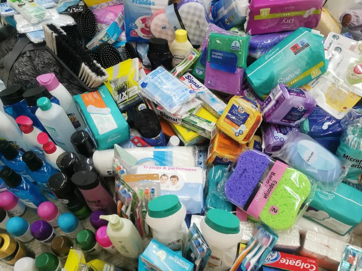 A loose mix of toiletries: toothpaste, toothbrushes, shampoo bottles, razors and hygiene products.