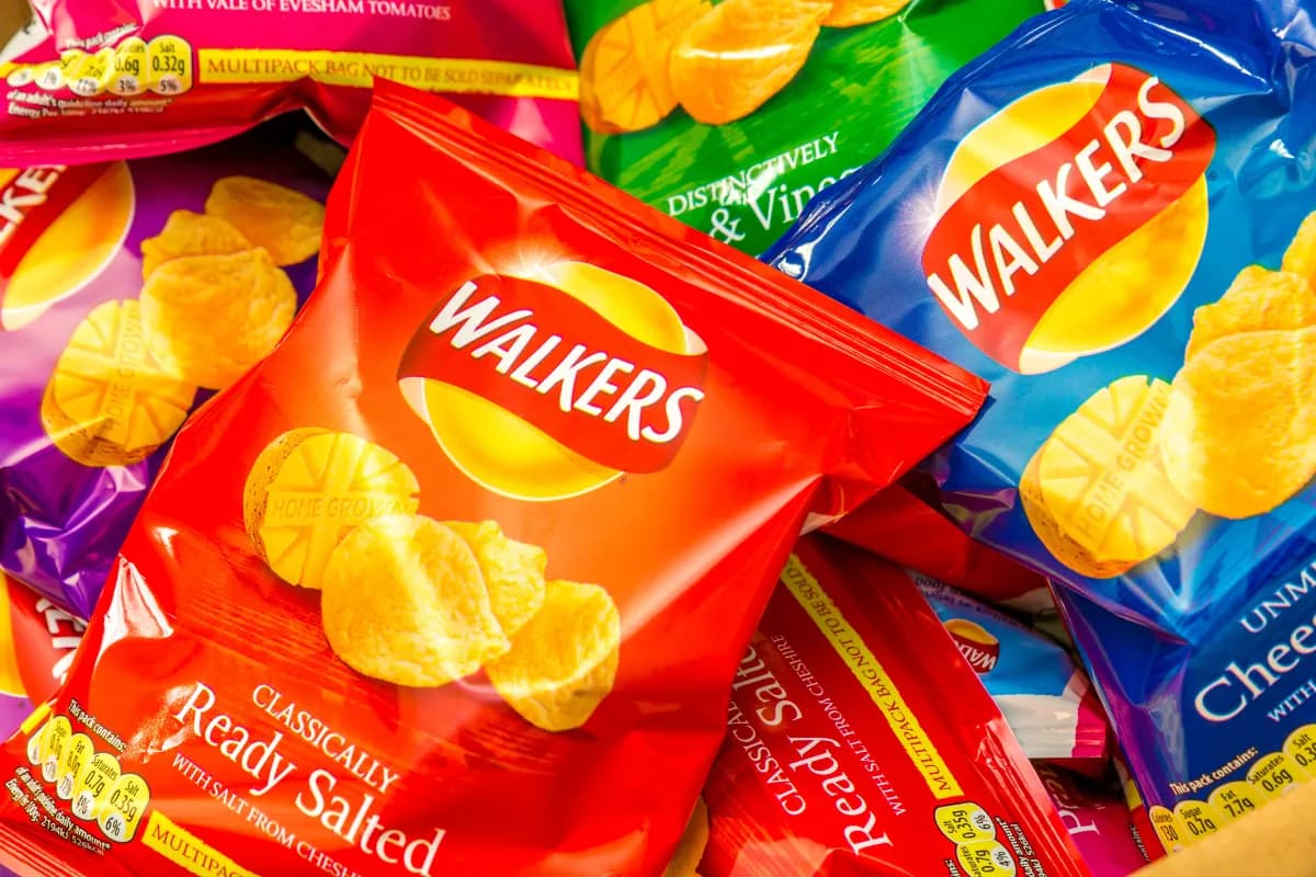 Loose multipack bags of crisps in mixed flavours piled in a case.